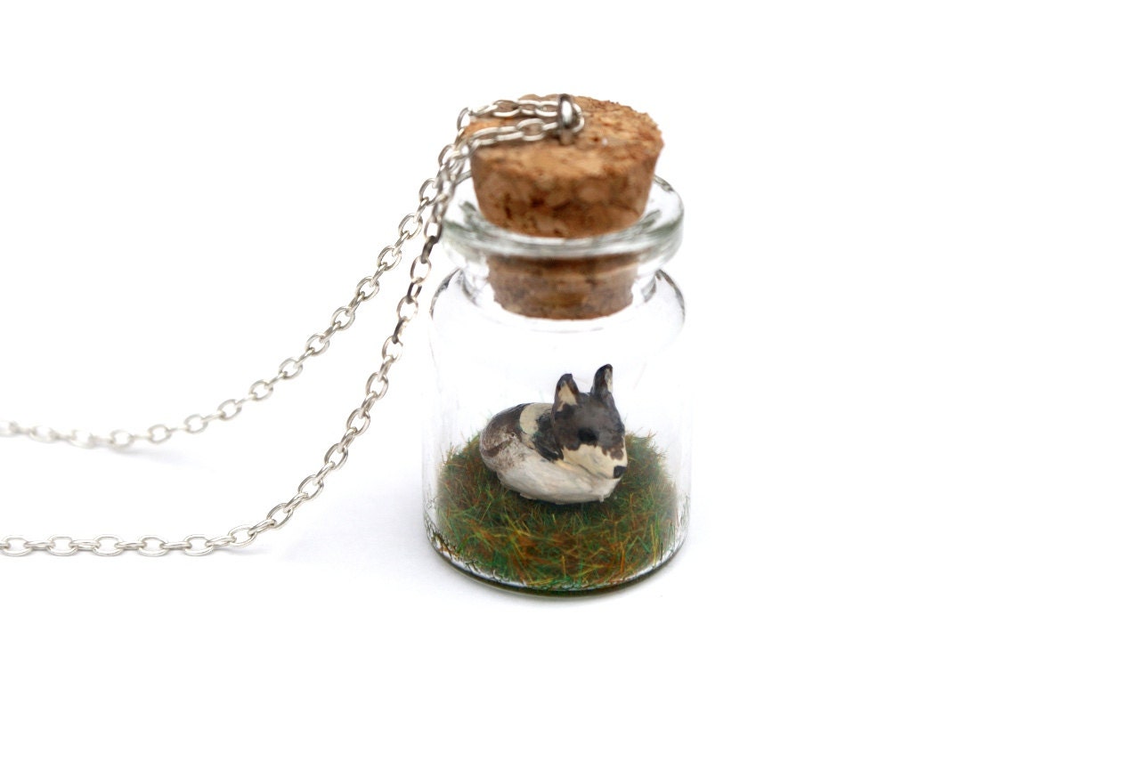 Miniature Wolf Jar Necklace - miniature spring wolf sat on a bed of grass inside a glass jar, on a 16 inch chain.