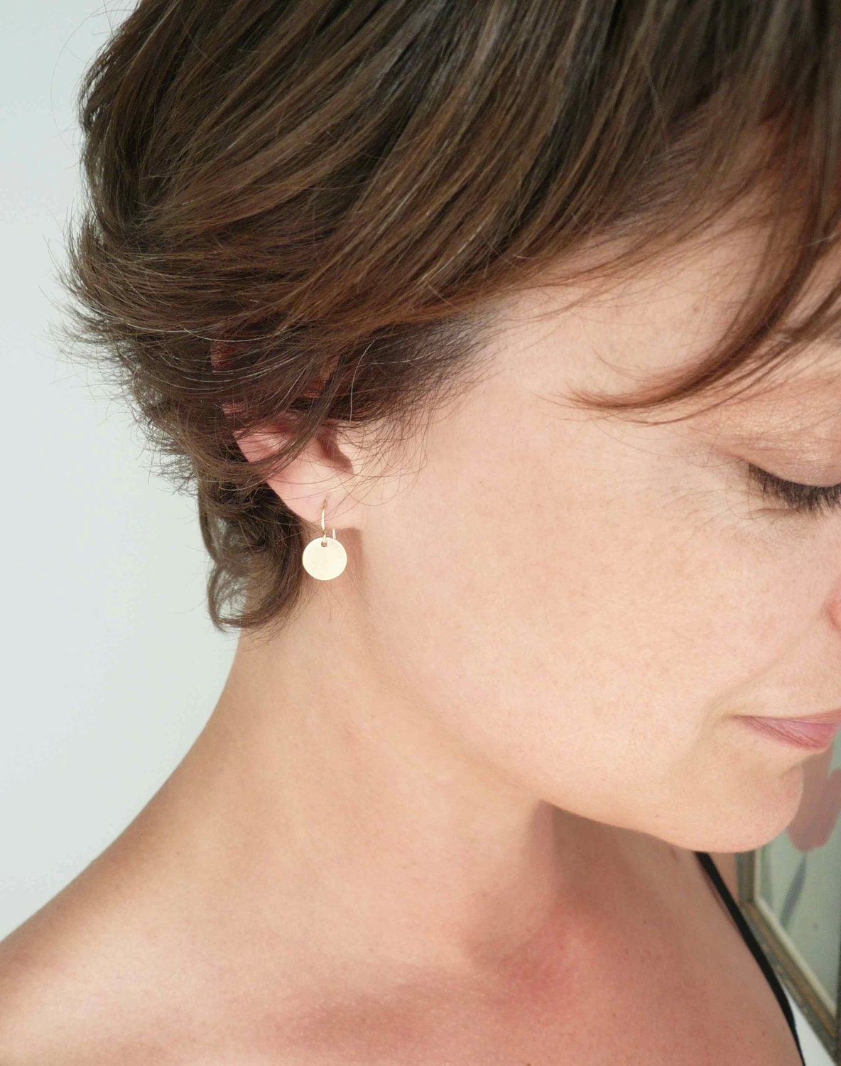 Gold circle earrings. Tiny brass discs on 14K gold fill GF ear wires. Dainty jewelry.
