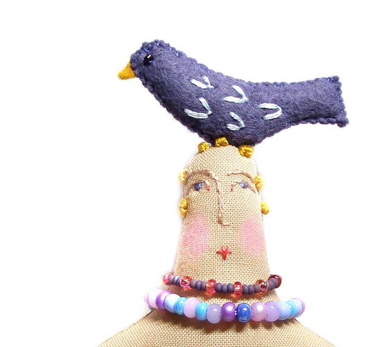 Handmade textile cloth art doll with bird on top of her head