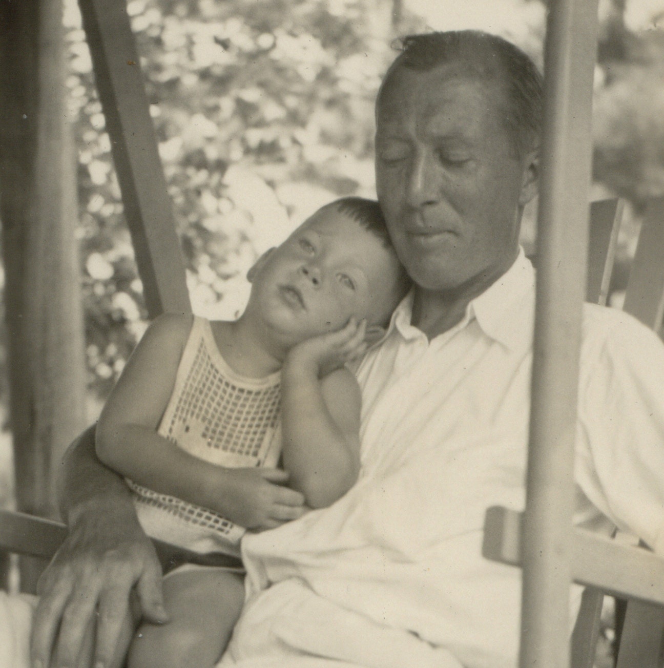 Vintage Sepia Photo of Sleepy Father Dressed in White with His Toddler Son in Lap Summer 1933