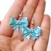 Origami bow earrings, made with light bluw with white flowers origami washi paper