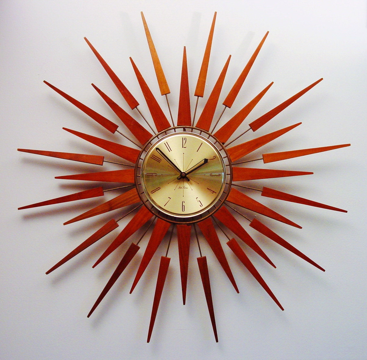 Mid-Century Modern Starburst Wall Clock by Seth Thomas, Starflower Design. 1960s. Teak Darts and Arrows.