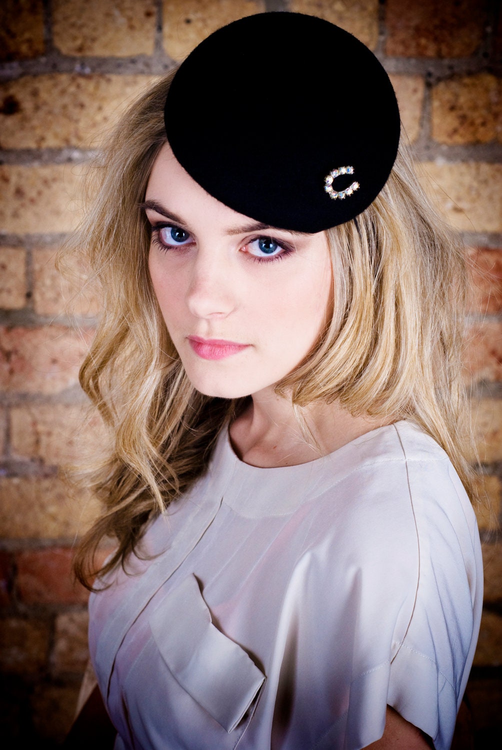 Handmade black fasinator with vintage horse shoe brooch.