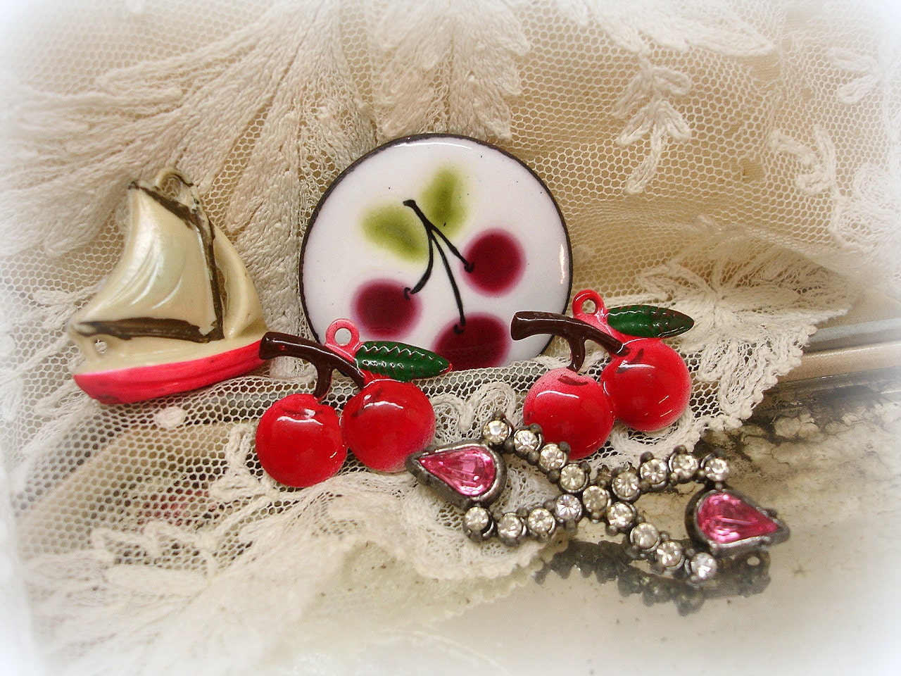 sWeet vintage cherry charms and findings . pot metal and rhineStone dress trim . enamel cherries . celluloid sailboat charm