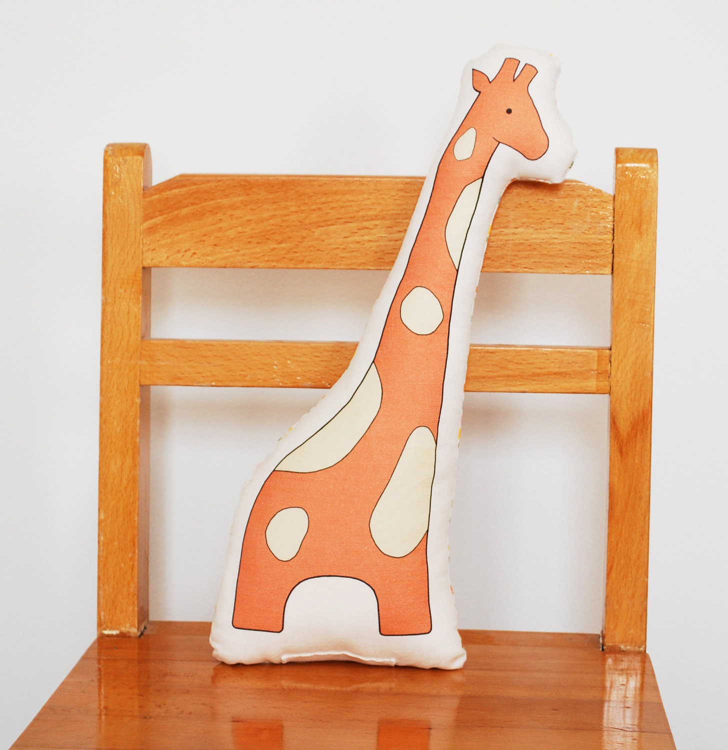 printed giraffe pillow in rose