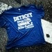 Detroit. One city under the hood. Tee. Unisex sizes