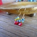 Tiny jade butterfly earrings with crocheted toppers made of gemstones