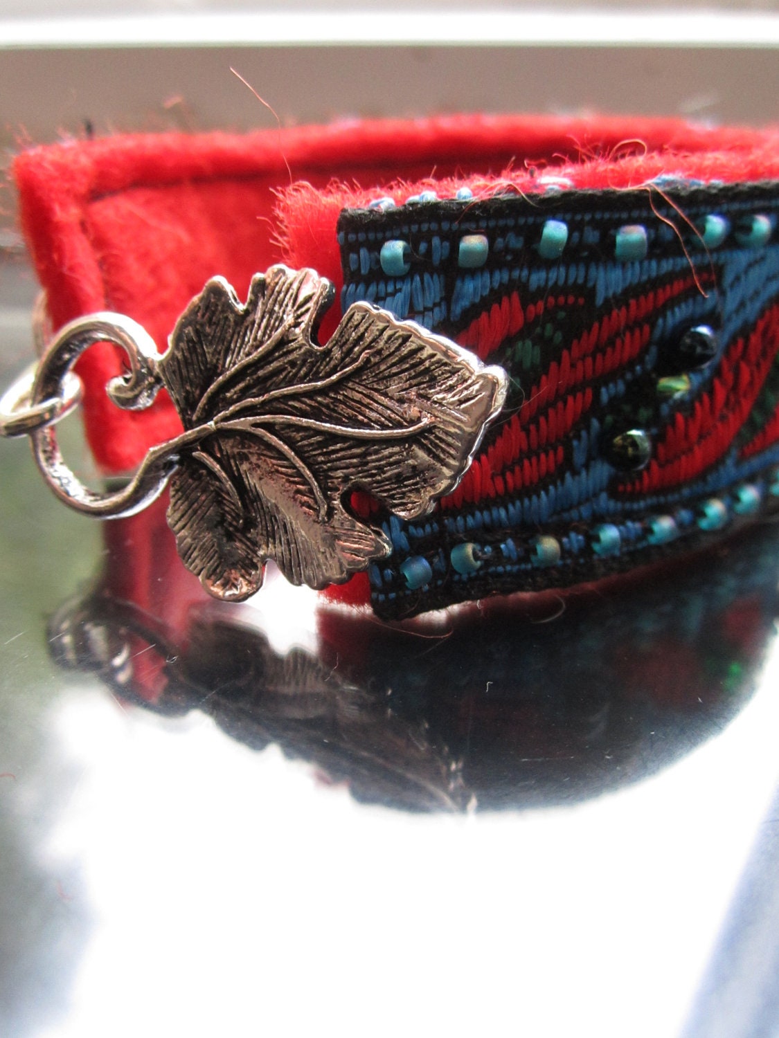 Leaf cuff bracelet in vibrant red and blue with beaded accents and leaf clasp