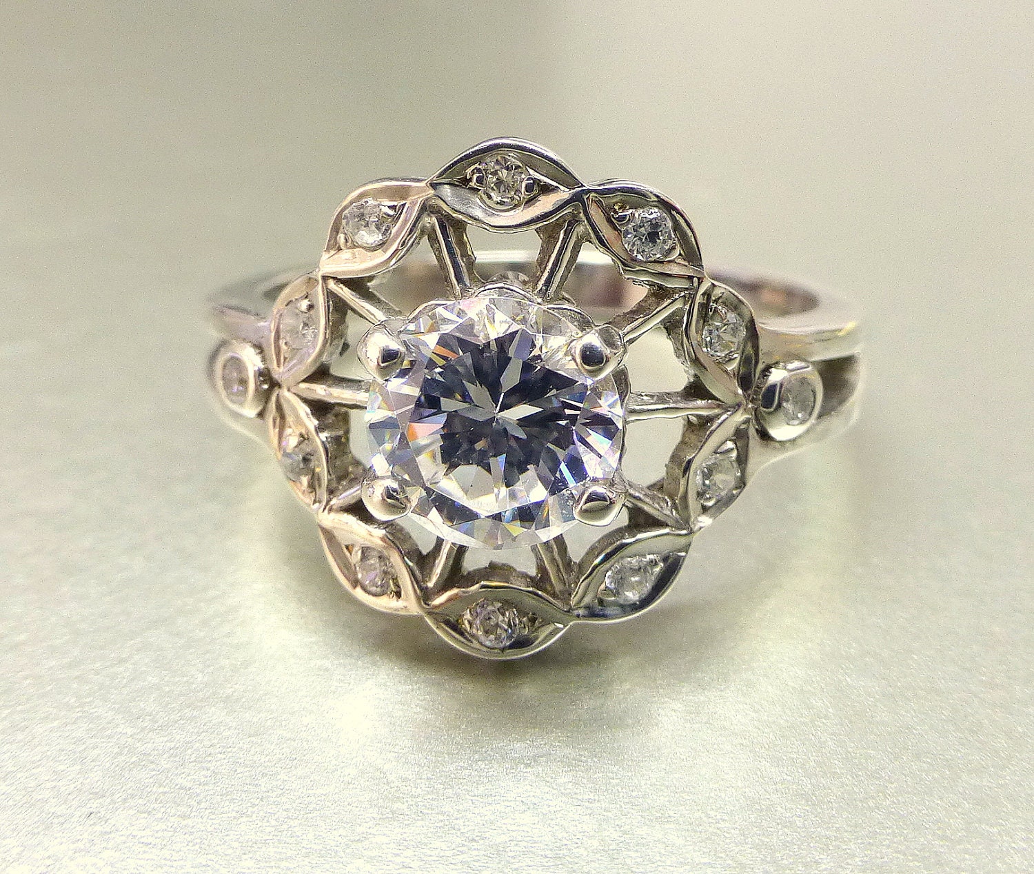 Flower engagement ring.  White sapphire center.