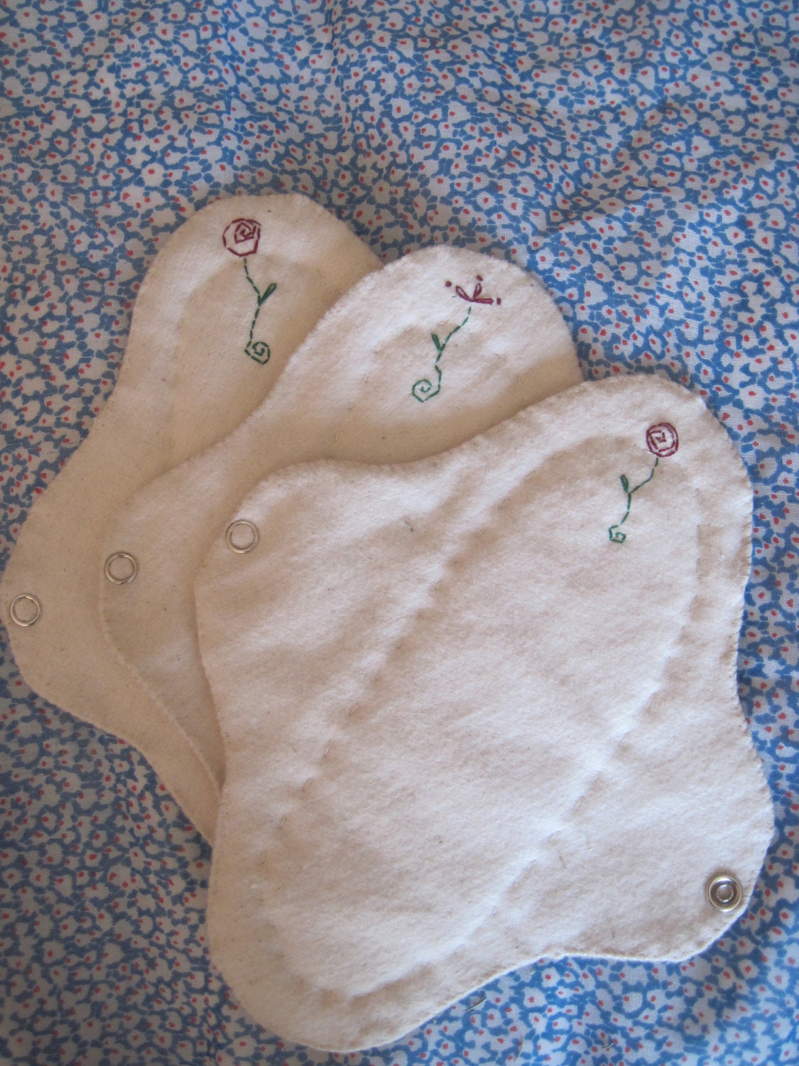 Three small Organic cotton reusable menstrual pads for the young woman