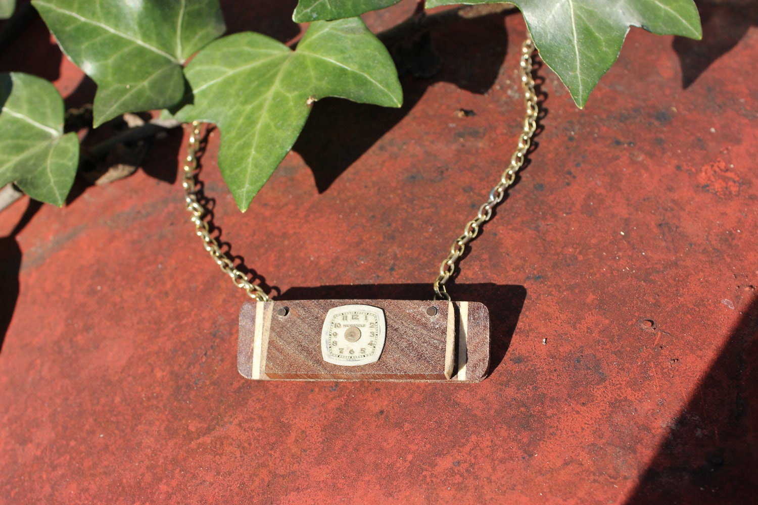 Pendant made with various types of wood with antique watch face and brass chain