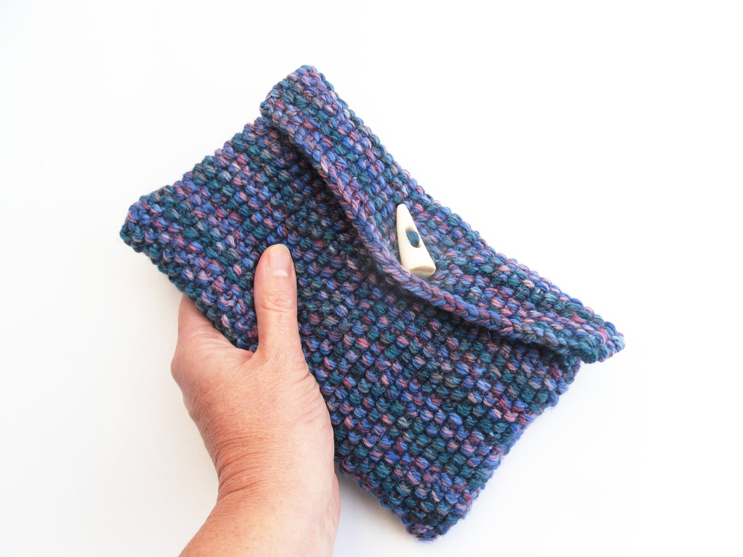 Clutch bag purse blue hand knitted in 80% wool yarn in moss stitch , horn toggle fastening fully felt lined.