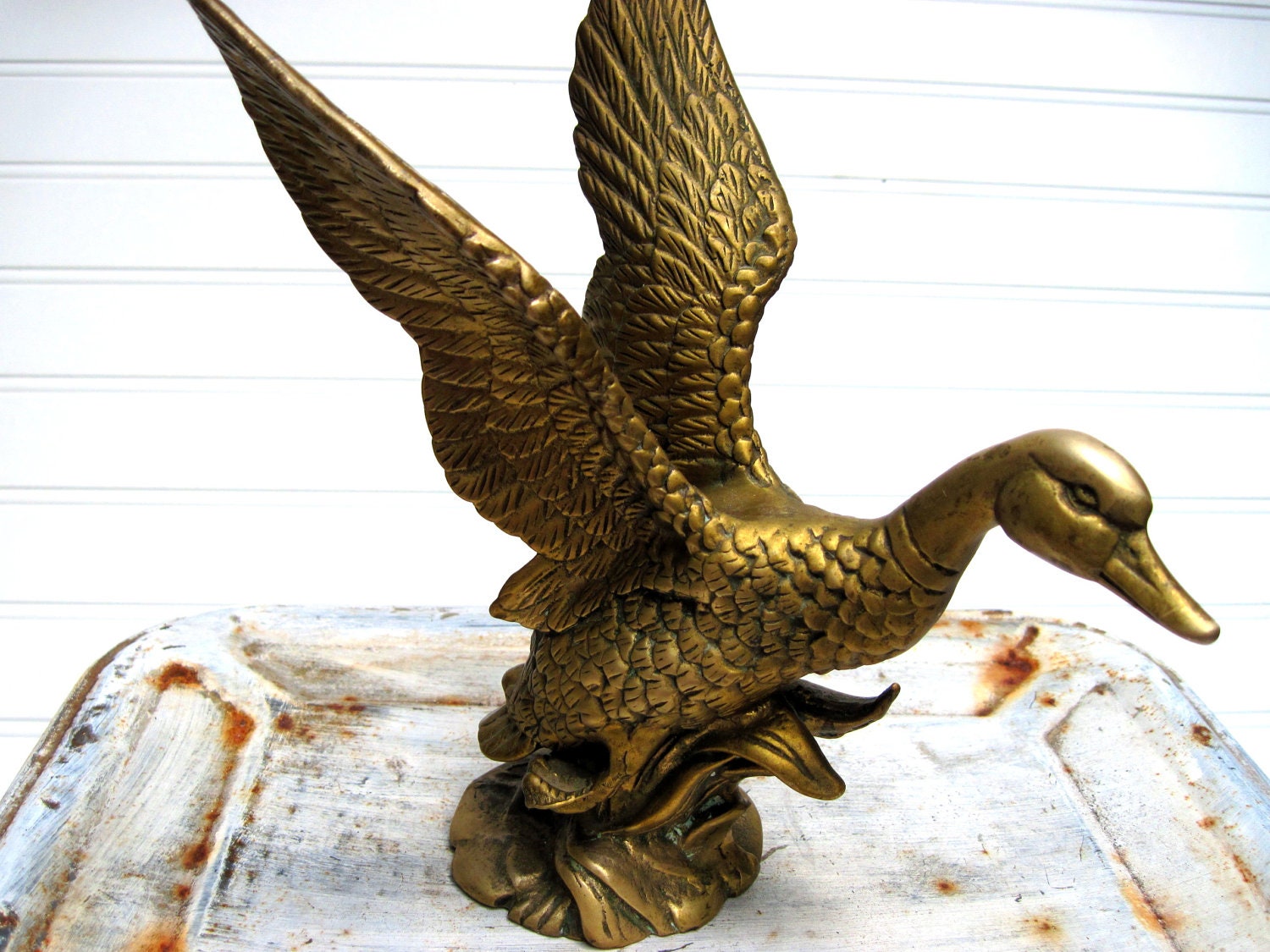 Brass duck sculpture flying mallard