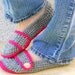 Crocheted slippers, booties, shoes, socks with a button strap in grey and fuchsia