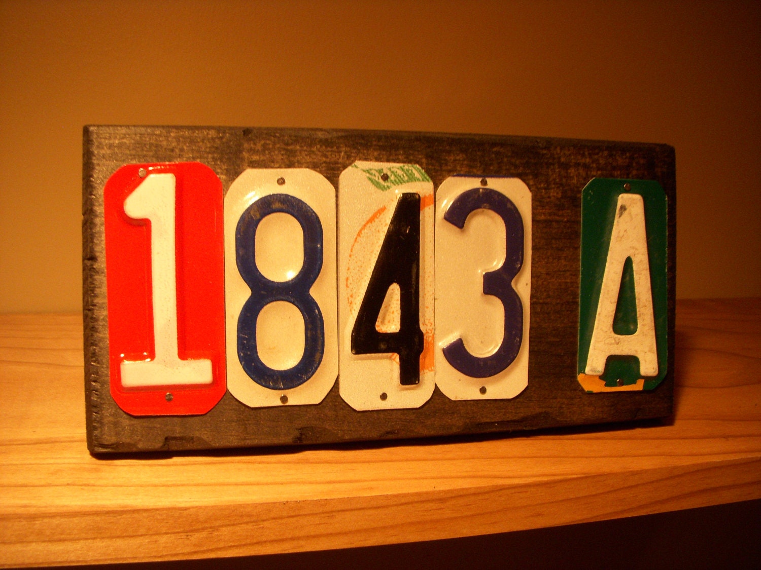 Custom made 5 number address sign made with recycled license plates.