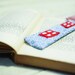 Blue and red bookmark.Funny fabric bookmark made in shape of house with red windows and white and red striped roof.