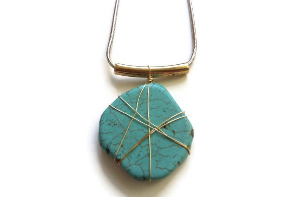 Turquoise wrapped in wire suspended on tube