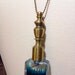 Pick Your Poison necklace: extra long antique brass ball chain, ornate perfume bottle filled with blue pigmented liquid