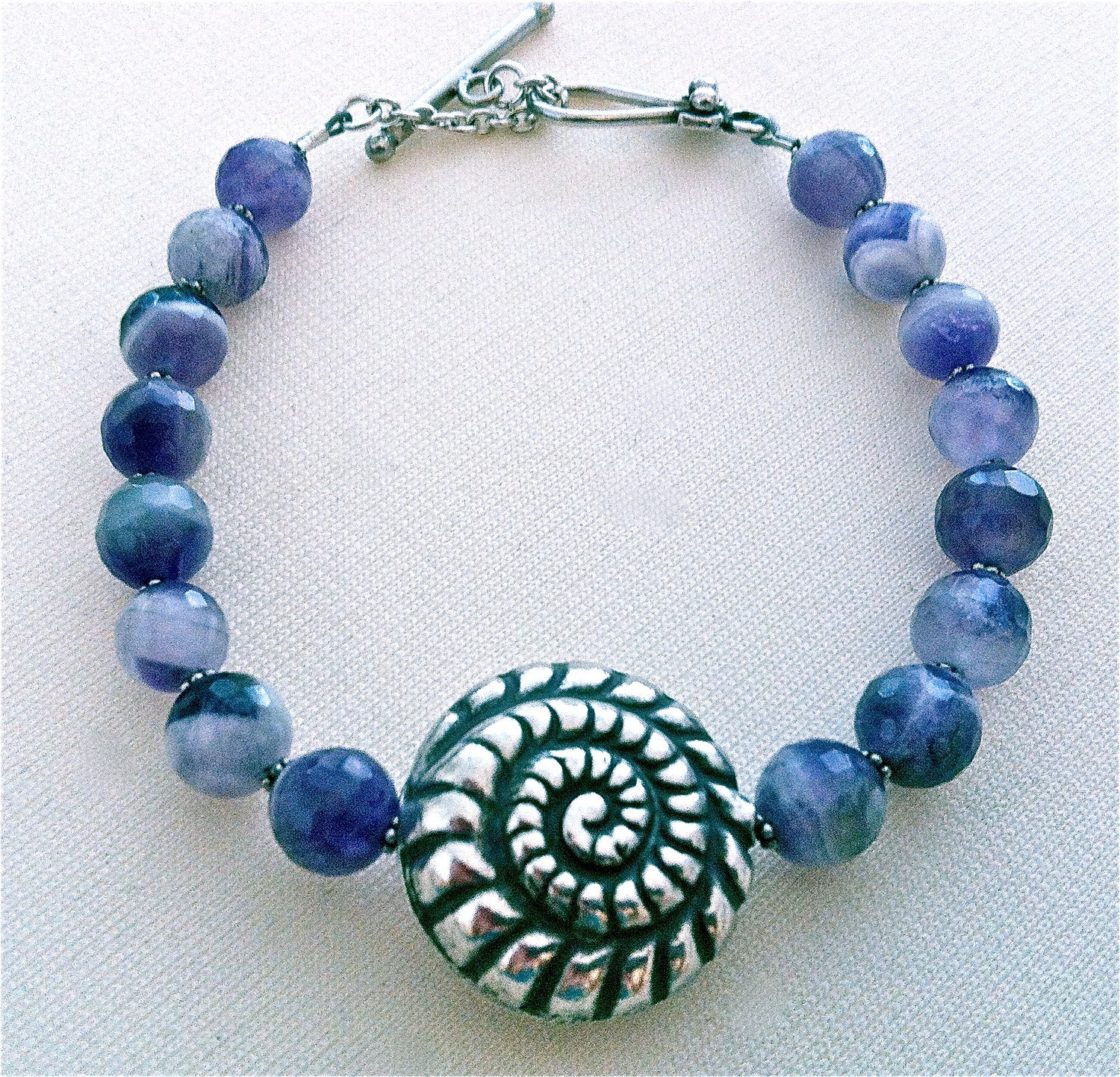 Amethyst quartz beaded bracelet with an ornate Bali silver focal bead.
