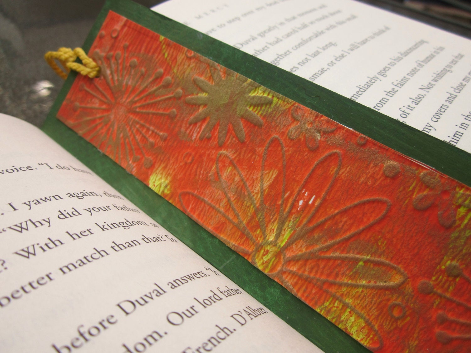 Gold flower bookmark with orange and bright green background with customizable border