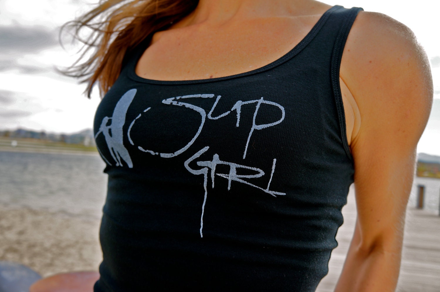 SUP Girl done in vintage looking silk screen on a black workout tank top with lace up back