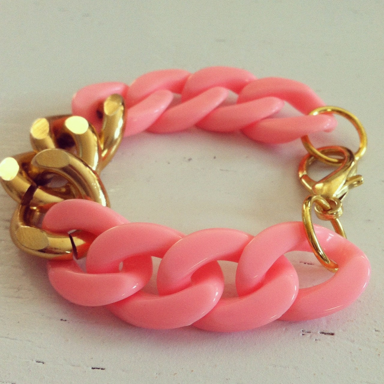 Three link gold and peachy pink chain bracelet