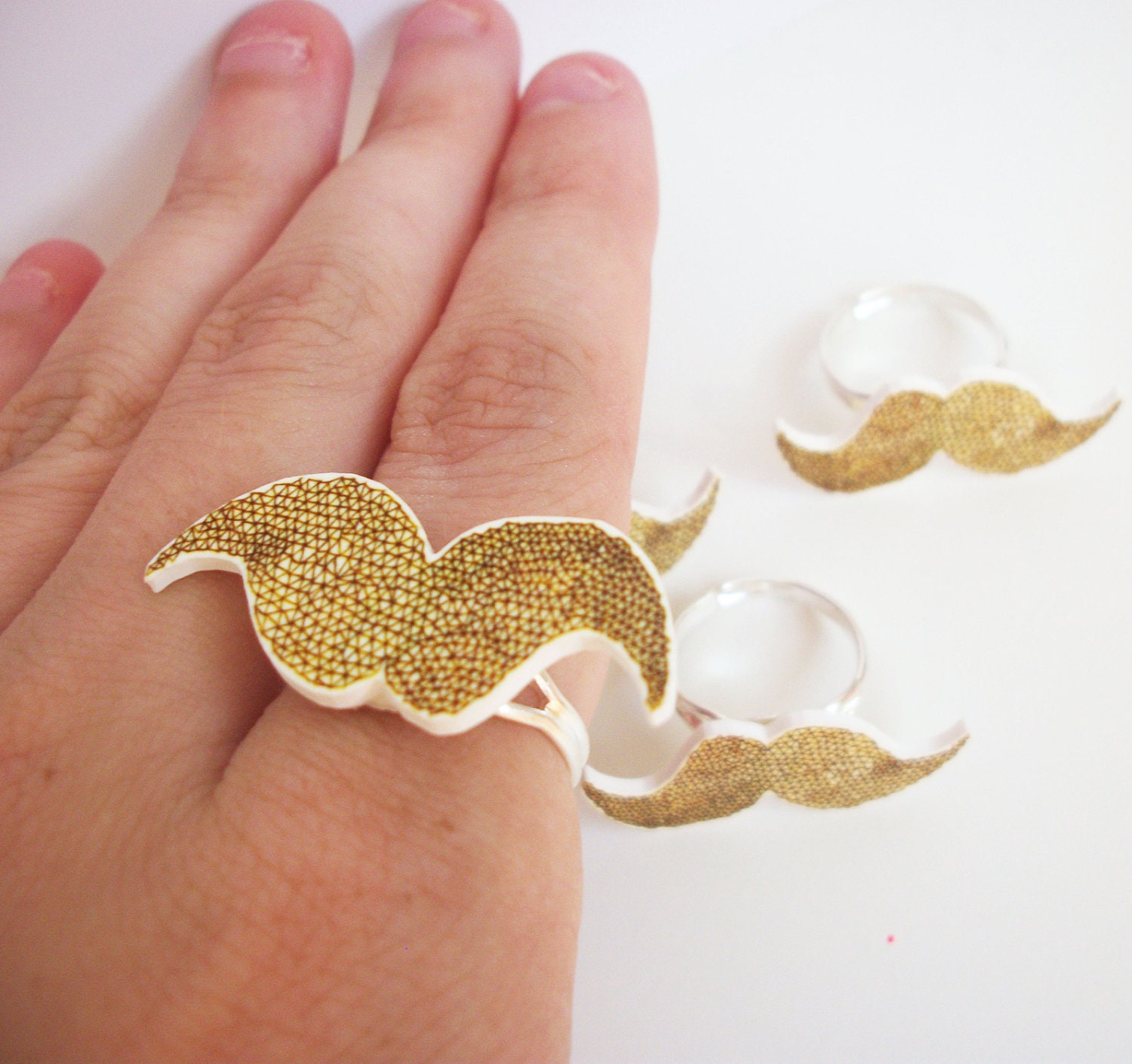 Orange ginger moustache geometric plastic ring. triangular pattern illustrated mustache ring.