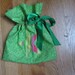 Christmas Reusable Gift Wrap with Colorful Striped Star Design on Green Polka Dot Fabric Bag