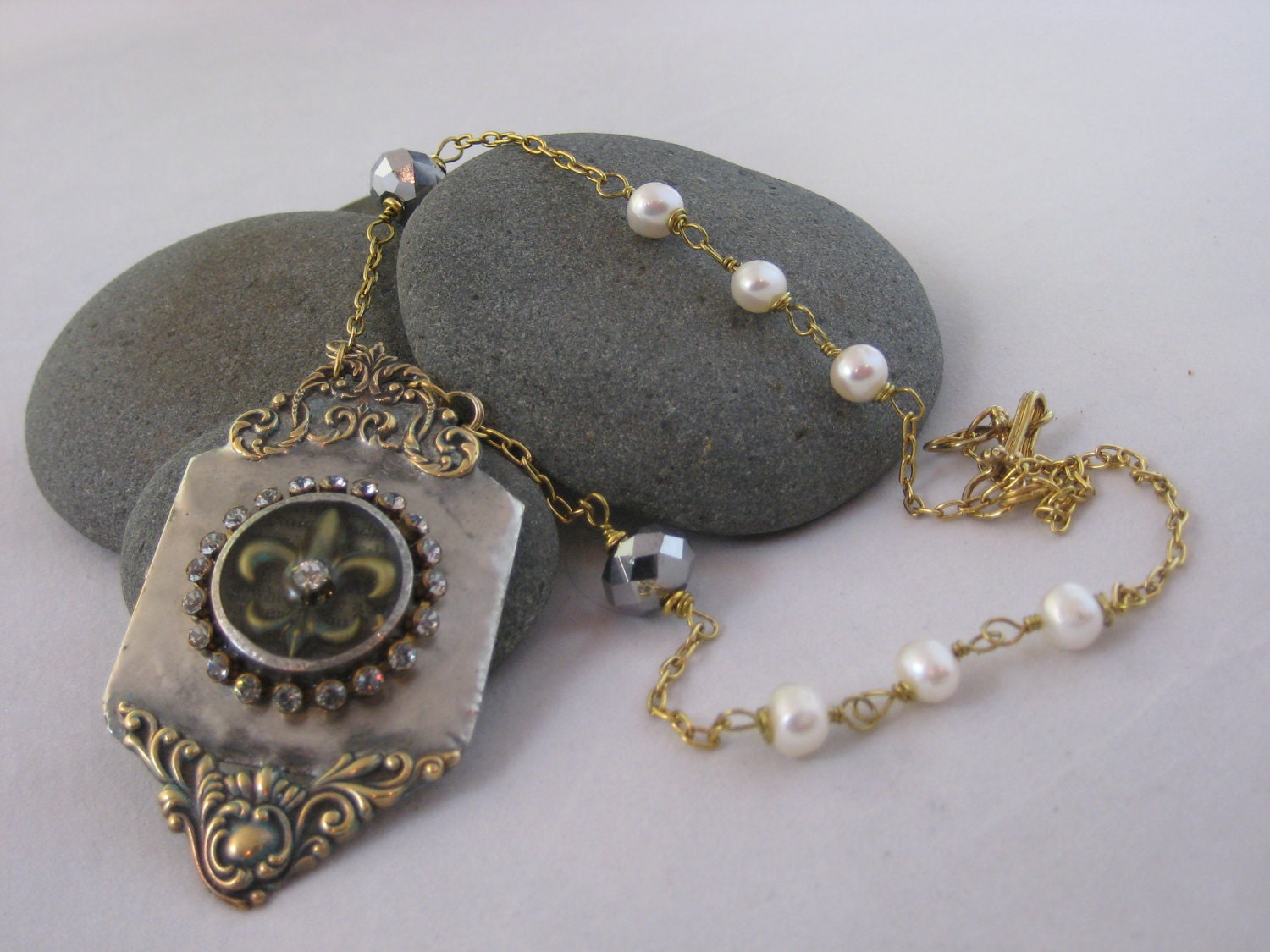 Vintage Inspired Hand Soldered Pendant Necklace with Fleur de Lys Encased in Resin surrounded by Rhinestones.