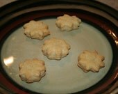 Six small peanut butter treats for dogs.
