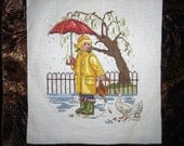 Cross Stitched Girl with a Bag in the rain.