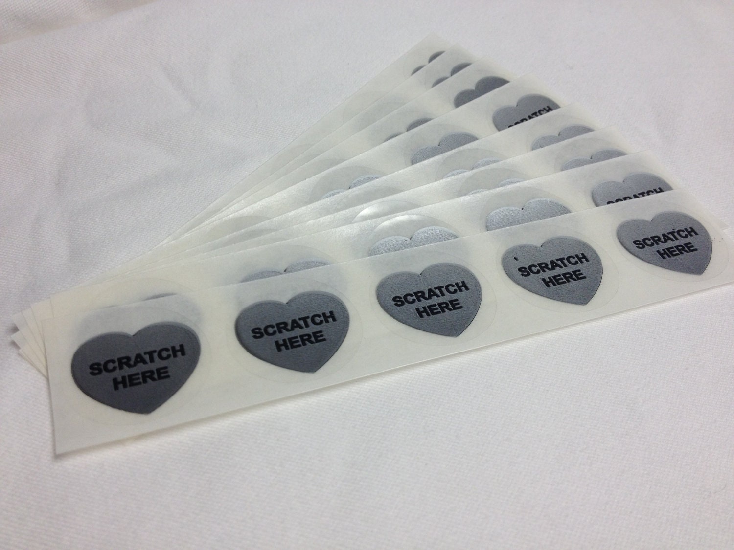 50 Silver 1 inch "scratch here" Heart scratch off labels stickers for games and promotions