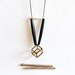 ONE LEFT geometric, tribal, metal cube, long black bone beads, white bone bead and black rope, long, beaded necklace