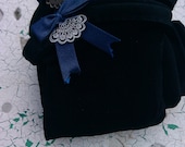 Black stockings with peacock blue satin bow, and sweet silvery fan