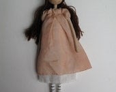 Clover, ooak small art doll with chestnut hair and hand-coloured peach dress.