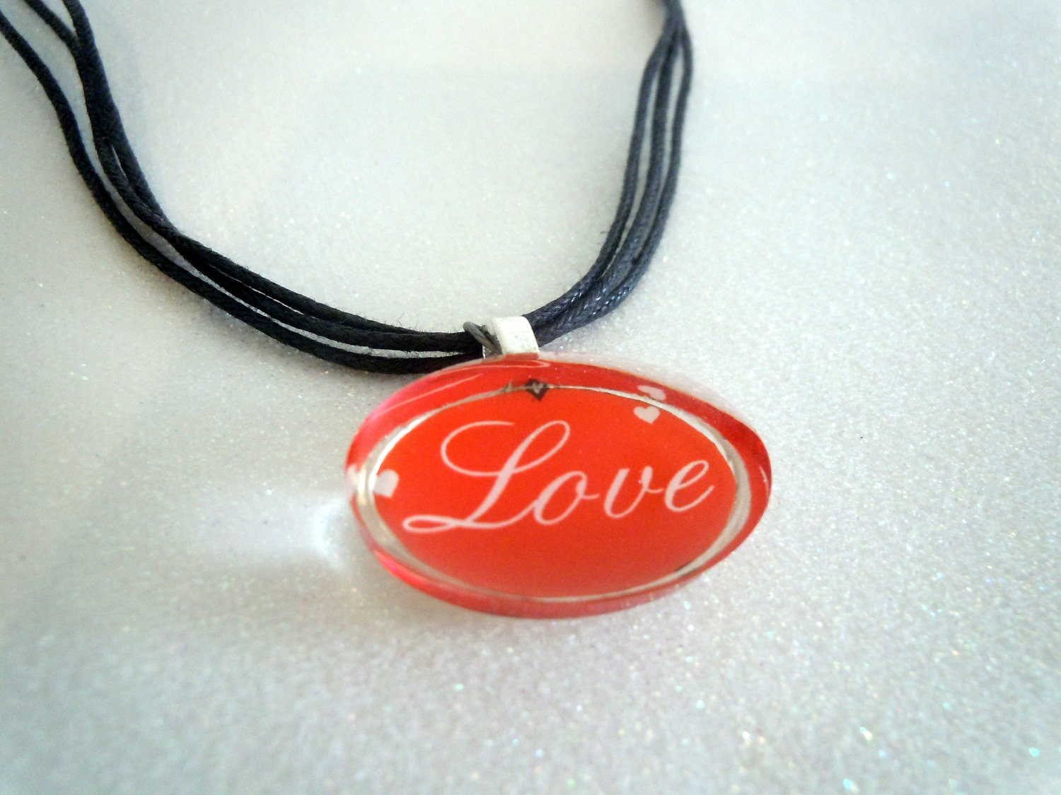Love charm on black cord necklace