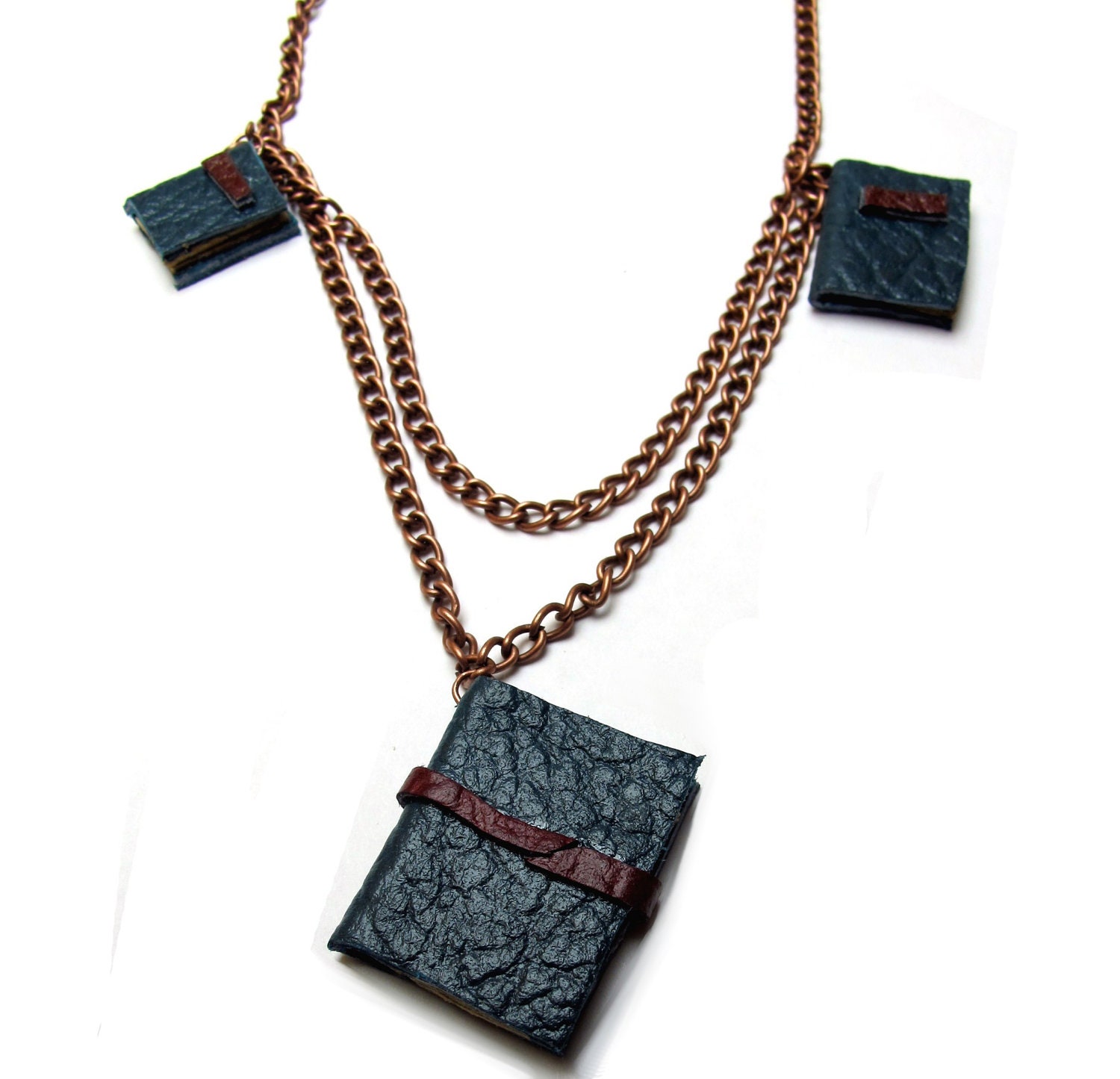 Book necklace, three decorative leather journals on chains.
