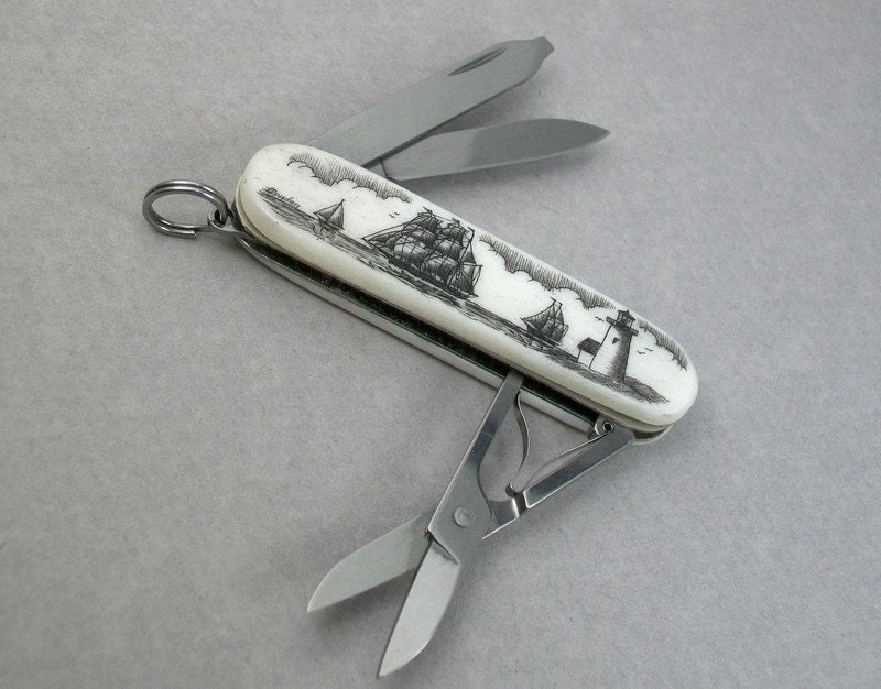 Scrimshaw Swiss Army Knife with bone handles and Nautical Scene featuring Lighthouse and Ships