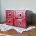 Vintage library card catalog four drawers wood - red finish - labels holders