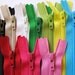 Ten 4 inch assorted YKK zippers - red, pink, yellow, green, bright aqua, black, beige, white