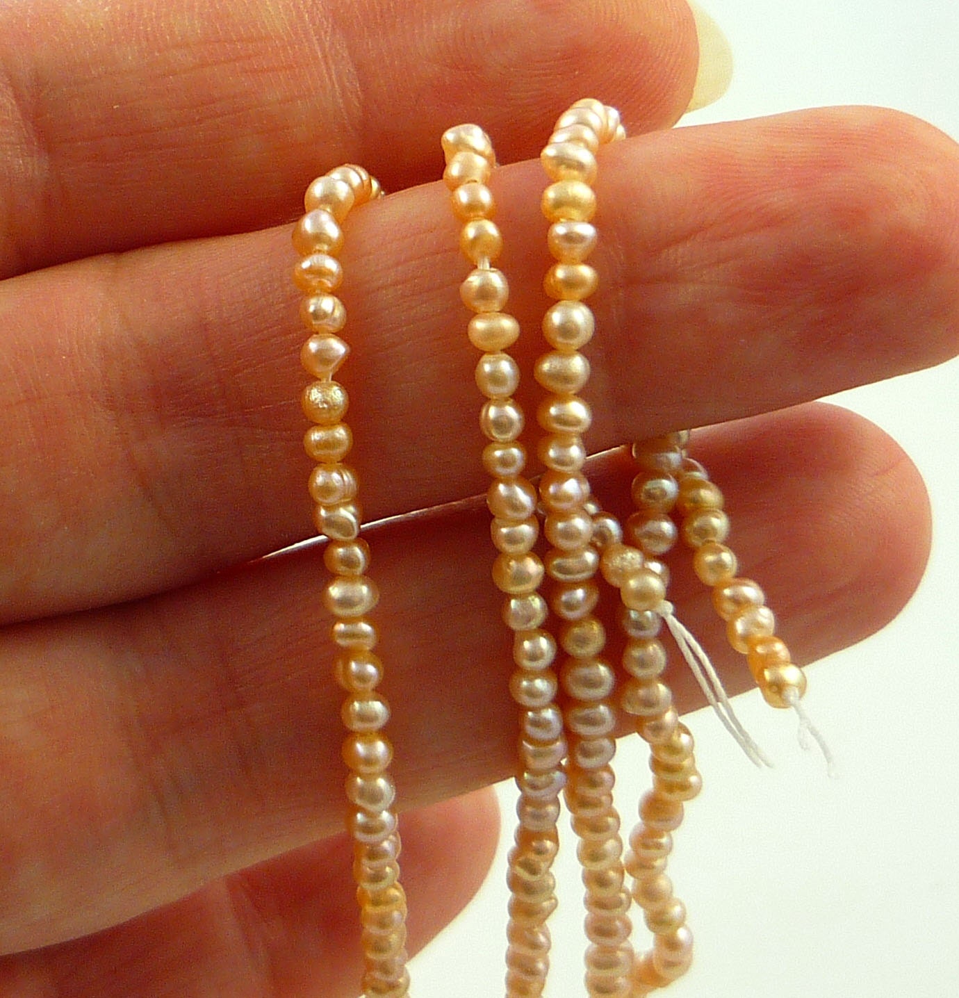Pretty tiny peachy pink champagne seed pearls 2-3mm natural colour 1/2 strand