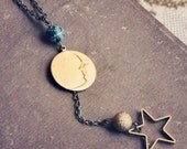 angela. a long beaded moon and star necklace.