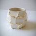 white and gold faceted bud vase