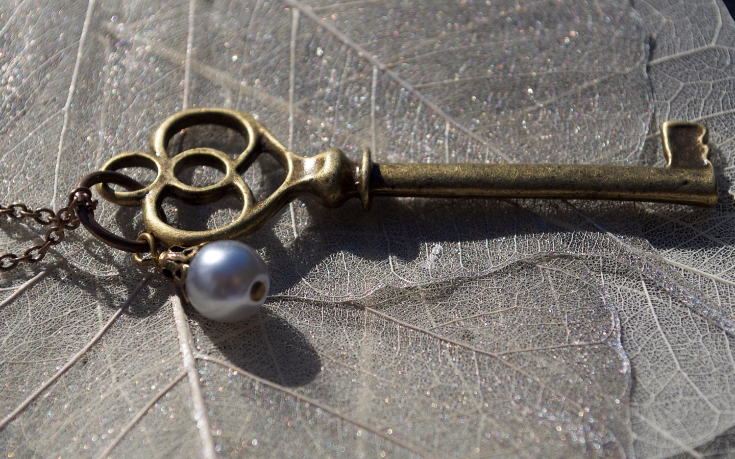 long brass key and grey pearl necklace