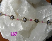 Purple and fuchsia swarovski crystals. Wire wrapped with 14 kt gold wire and gold tone flower boxes.