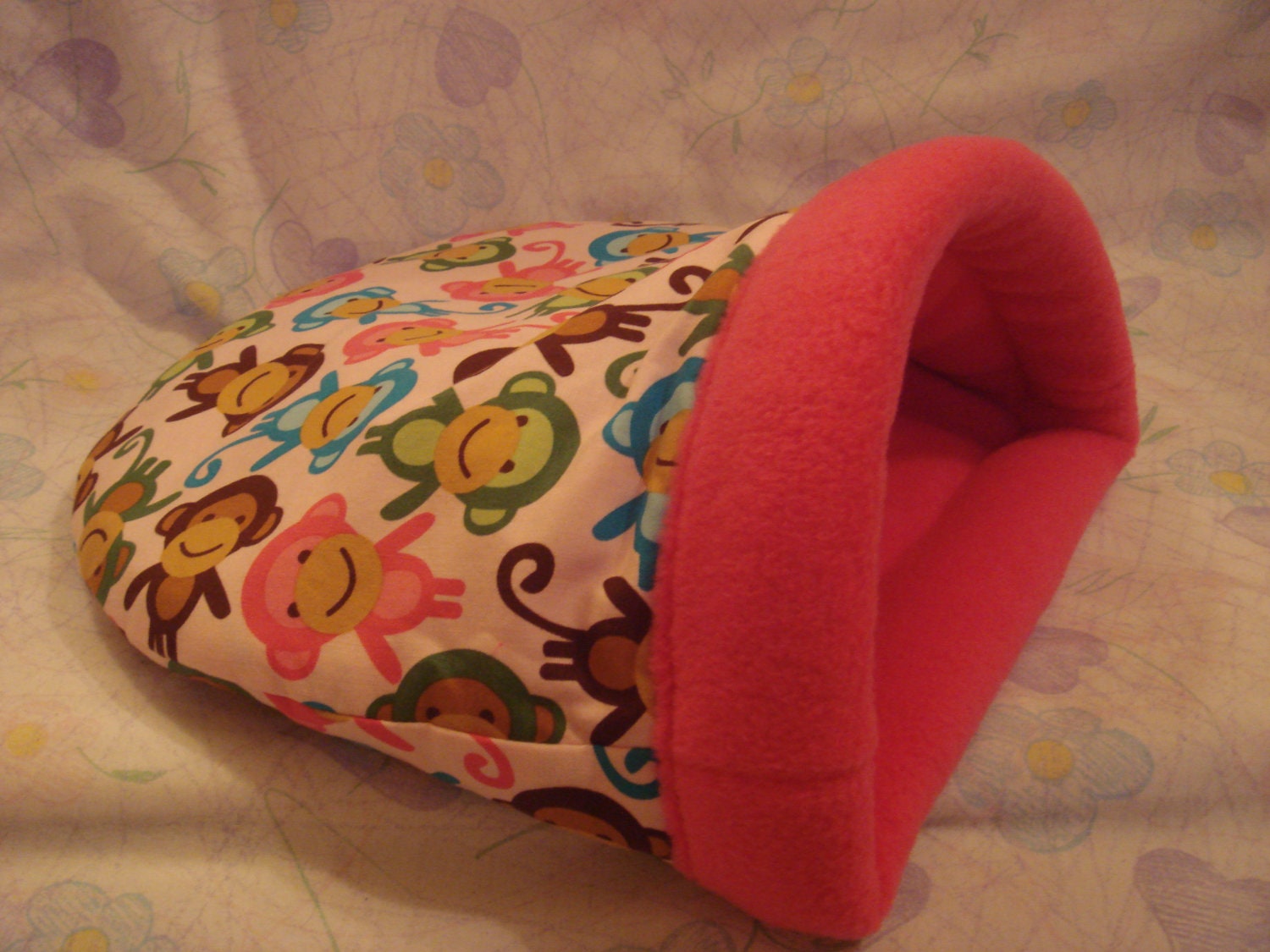 Plush snuggle sack for guinea pigs in a funky monkey design with super soft hot pink fleece