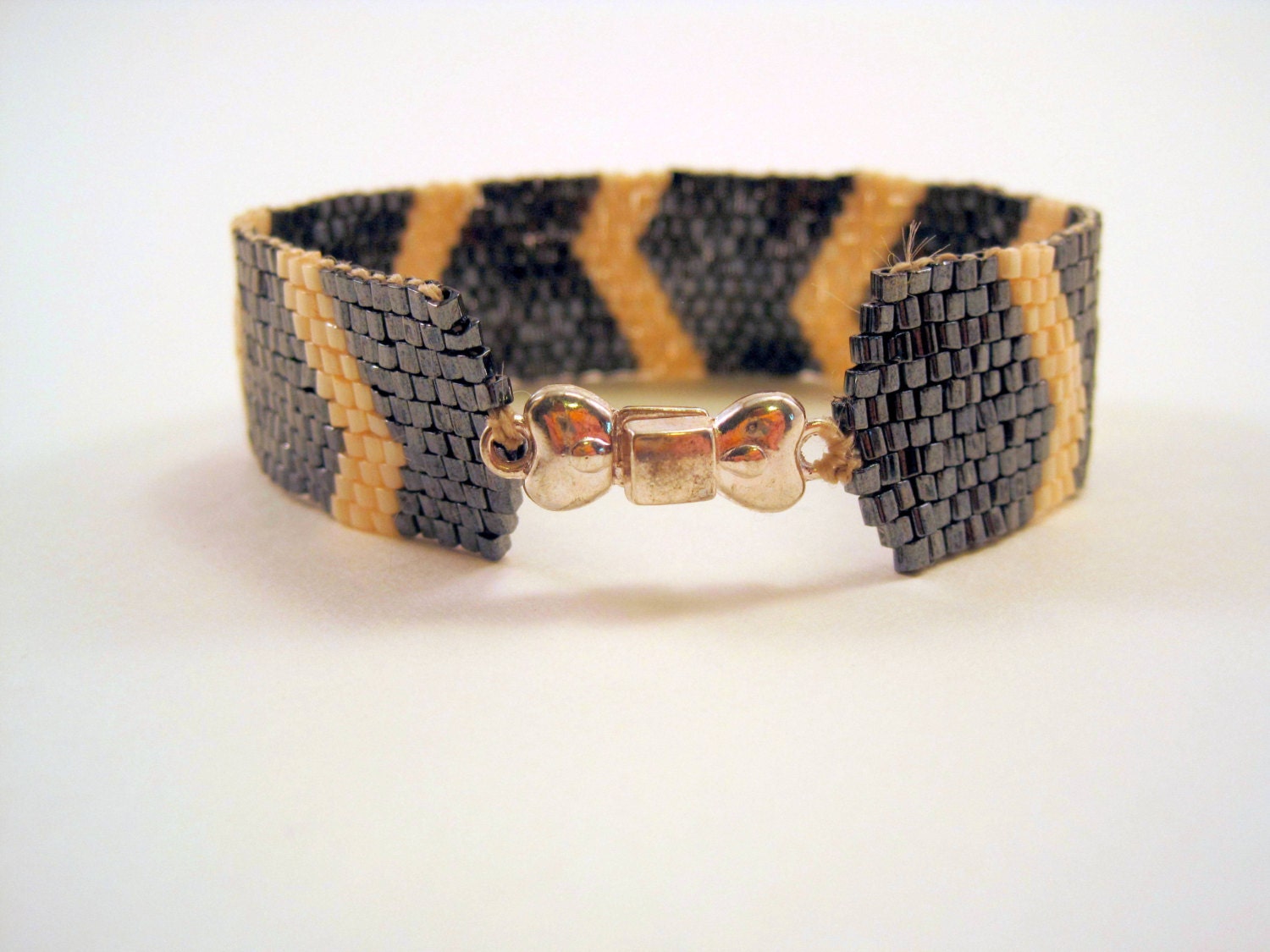 gun metal and ivory square delica beads abstract chevron zigzag asymmetrical snake silver bow magnetic clasp