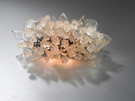 Wall light fixture. Transparent flowers and leaves.
