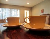 Two (2) vintage 1960s yellow and white ceramic tea cups with saucers