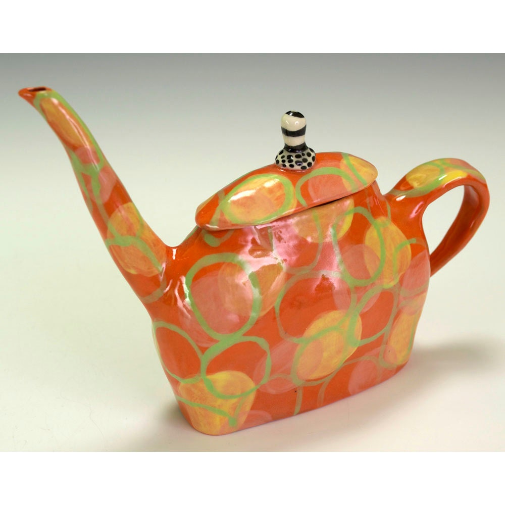 Orange Teapot with Floating Circles.